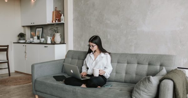 woman-sitting-on-sofa-while-working-at-home-4050295